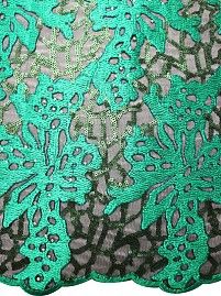 a green and black lace with flowers on it