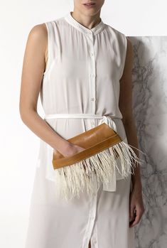 Bring a glamorous edge to your evening look with the Domna design clutch leather bag. Handmade of fine quality leather and silky feathers, this boho chic evening bag comes in 2 colors, camel brown (waxed tan) and black. ● Size: width 29 x height 16cm (width 11.4 x height 6.3 inches) ● Without lining ● Dust bag included Discover the whole collection with our unique leather bags: www.etsy.com/shop/GreekChicHandmades?ref=seller-platform-mcnav&section_id=15827194 Back to the shop: www.etsy.com/shop/GreekChicHandmades SHIPPING Every clutch is handmade upon order and ready to be shipped in 3-7 business days. We ship from Greece to all over the world via DHL express with delivery time 1-5 business days.  Please be aware that delivery may experience delays due to your country's customs procedures. Chic Rectangular Clutch With Fringe, Chic Brown Handheld Clutch, Chic Rectangular Fringe Clutch, Leather Envelope Clutch With Dust Bag, Handheld Leather Clutch For Parties, Elegant Evening Bag With Fringe, Formal Rectangular Evening Bag With Fringe, Elegant Fringe Clutch For Formal Occasions, Elegant Fringe Clutch For Formal Events