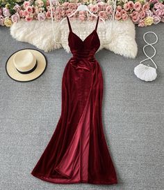 Unleash the allure of classic glamour with this Vintage Velvet Burgundy Gown. The rich, deep hue of burgundy exudes a luxurious warmth, while the plush velvet material provides a tactile delight, ensuring this gown is as sumptuous to the touch as it is to the eye. The fitted bodice with a sweetheart neckline and spaghetti straps offers a timeless and seductive appeal, perfect for an evening of elegance.The gowns silhouette gracefully skims the body, flowing into a gentle flare at the hem that ad Fitted Red Velvet Floor-length Dress, Red Fitted Floor-length Velvet Dress, Elegant Winter Banquet Gown, Fitted Floor-length Red Velvet Dress, Velvet Gown For Prom Season, Velvet Fitted Dress For Red Carpet, Red Carpet Velvet Fitted Dress, Elegant Burgundy Velvet Evening Dress, Velvet Prom Gown For Prom Season