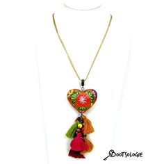 Hand painted heart Necklace. Hand painted by artisans in Chiapas Mexico, this lovely necklaces are decorated with wooden hearts and many bead strands to give the ethnic a more modern look. Adjustable height so you can wear it close to the neck or way below. Dimesions: 22 inches long. Unique Heart-shaped Festival Jewelry, Heart Charm Necklace For Festivals, Adjustable Bohemian Heart Pendant Jewelry, Heart Charm Necklace For Festival, Handmade Spiritual Necklaces As Souvenir, Traditional Multicolor Heart Beads Necklace, Heart-shaped Necklace With Heart Charm For Festivals, Bohemian Heart Shaped Necklace, Adjustable Multicolor Necklace With Large Pendant