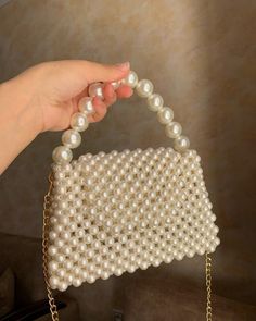 Zuruj Pearl & Crystal Handmade Bags Elegance in Every Detail Introducing the new line of luxurious handmade bags by Zuruj, meticulously crafted to bring timeless elegance to your collection. These exquisite bags are a perfect blend of pearls and crystals, reflecting the brand's commitment to quality and artistry. Features: - Handcrafted Masterpiece: Each bag is painstakingly handcrafted, ensuring that no two pieces are alike. - Luxurious Materials: Adorned with lustrous pearls and sparkling crys Pearl Handle Tote Bag For Gift, Gift Tote Bag With Pearl Handle, Gift Pearl Handle Shoulder Clutch, Wedding Tote Bag With Pearl Handle, Pearl Bags Perfect As Gifts, Pearl Handle Pouch Evening Bag, Formal Rectangular Pearl Bag, Formal Rectangular Pearl Bags, Everyday Handheld Pearl Shoulder Bag