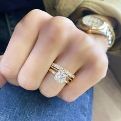 a woman's hand with two rings on it and one ring in the middle