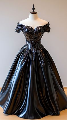 a black ball gown is on display in a room with white walls and wood flooring