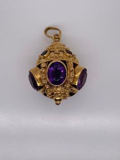 Vintage 18k yellow gold talisman pendant with amethyst and multi color gemstones. There are 5 bezel set amethyst gemstones that measure about 11 x 9mm. There are 2 pink tourmaline, 2 green tourmaline, and 1 citrine set in bezels around the top. The charm weighs 21.48 grams of gold. Luxury Amethyst Pendant Jewelry, Antique Multi-stone Yellow Gold Jewelry, Antique Yellow Gold Multi-stone Jewelry, Luxury Yellow Gold Pendant Gemstones, Yellow Gold Gemstone Amulet Jewelry, Yellow Gold Amulet Jewelry With Gemstone, Gold Amethyst Round Pendant Jewelry, Yellow Gold Multi-stone Round Pendant Jewelry, Purple Amethyst Amulet Jewelry