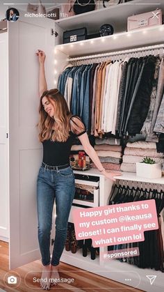 a woman standing in front of a closet full of clothes