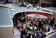 an aerial view of people standing around a carousel