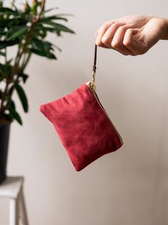 Made with a red sueded fabric, lined with a bird print cotton, and finished with a brown suede zipper pull, you'll adore this sweet and stylish little pouch. These purses are a perfect size for little things, like credit cards and cash. Your undersized items can tuck in here, and fit into a bigger purse or pocket. The sturdy brass zippers make them easy to use. 5.5" X 3.75" Designed and handmade at the Ash & Rose studio in Massachusetts Limited edition Red Bag With Zipper Pocket For Gift, Red Pouch With Cell Phone Pocket For Everyday Use, Red Pouch With Removable Feature As A Gift, Red Clutch Pouch For Gift, Red Clutch Pouch For Daily Use, Red Bag With Zipper Pouch As Gift, Red Wallet With Zipper Pocket For Everyday Use, Red Zipper Pouch Wallet Clutch, Red Zipper Closure Pouch For Everyday Use