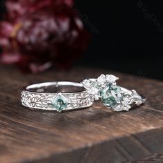 two wedding rings sitting on top of a wooden table