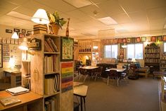 a library with tables, chairs and bookshelves filled with lots of different types of books