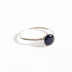 A B O U T : A delicate ring sterling silver with a circle solitaire natural black onyx gemstone cabochon cut.  Gold option available. M E A S U R E M E N T S : Stone 6mm wide. Band 1.2mm thick M A T E R I A L S : Solid sterling silver. Natural black onyx. All materials sourced locally. M E A N I N G : Black Onyx is a popular and powerful gemstone. The keywords behind Black Onyx meaning are: intuition, rejuvenation, divination, strength, change, balance, grounding, focus, self-confidence, banishi Minimalist Oval Cabochon Jewelry, Minimalist Ring With Polished Round Stone, Minimalist Rings With Polished Round Stone, Sterling Silver Cabochon Rings, Sterling Silver Jewelry With Smooth Bezel, Minimalist Polished Moonstone Ring, Minimalist Round Sapphire Ring With Polished Finish, Minimalist Jewelry With Polished Round Stone, Silver Jewelry With Smooth Bezel And Round Band