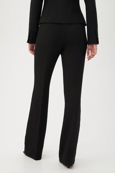 From day to night, these streamlined pants are sure to be a go-to in your year-round wardrobe. Stretch Hi-Line Suiting offers a comfortable stretch with a medium weight for supportive and comfortable all-day wear. Flat front High-waisted Kick flare hem Side zipper Full-length inseam Inseam: 32.5" Runs true to size Model is 5'10", wearing size 2 See Women's Size Guide FABRIC: Hi-Line Textured Suiting Sustainable Fabrication 69% Polyester, 28% Viscose Lenzing™ Ecovero™, 3% Elastane Dry clean only Round Wardrobe, Bordeaux Color, Line Texture, Bryant Park, Kick Flares, Trina Turk, Medium Weight, Side Zipper, Black Pants