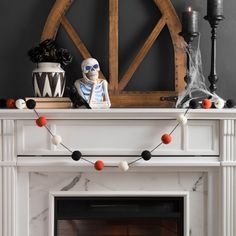 a white fireplace with halloween decorations on top and the words kirkland's above it