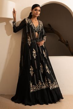 Black long cape with scattered floral embroidery using sequins. Paired with an inner blouse with sequin butti work. Comes along with a lehenga with embroidered hem. - Aza Fashions Festive Black Sets With Cape Sleeves, Festive Black Set With Cape Sleeves, Festive Black Cape Sleeve Sets, Black Hand Embellished Choli With Traditional Drape, Traditional Black Hand Embellished Lehenga, Black Resham Embroidered Outerwear For Festive Occasions, Black Long Sleeve Choli For Wedding, Long Sleeve Black Choli For Wedding, Black Long Sleeve Wedding Choli