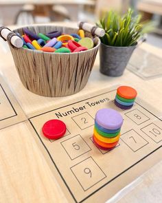 a wooden table topped with lots of colorful toy blocks and a bowl filled with toys