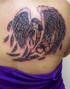 a woman with an angel tattoo on her back