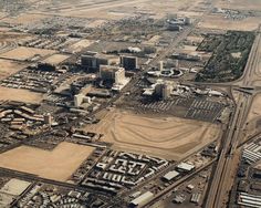 an aerial view of a city with lots of buildings and roads in the foreground