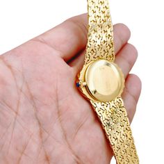 Ladies Corum 26mm x 30mm Oval Vintage 18K Yellow Gold Watch with Gold Dial and Weave Bezel. Pre-Owned SN# 163**** Brand: Corum. Dial Color: Gold. Type: Wristwatch. Gender: Women's. Condition: Excellent. Bezel: 18K Yellow Gold. Total Weight: 62 Grams. Case Size: 26mm x 30mm. Movement: Quartz (Battery). Band Material: 18K Yellow Gold. Bezel Material: 18K Yellow Gold. Bracelet Size: Fits 6.5" to 6.75" Wrist. Warranty: One (1) Year Limited Service Warranty. Oval Diamond Watch For Formal Occasions, Formal Oval Diamond Watch, Formal Oval Diamond Watch With Diamond Hour Markers, Oval Quartz Watch For Formal Occasions, Yellow Gold Diamond Watch With Polished Finish, Luxury Oval Jewelry With Diamond Hour Markers, Elegant Yellow Gold Round Jewelry And Watches, Gold Oval Watch With Diamond Hour Markers, Gold Oval Watches With Diamond Hour Markers