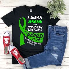 "* All shirts are unisex. * Product measurements may vary by up to 2 inches. * All Designs are originally made by myself or my team.  Brain Injury Awareness shirt with the quote \"Traumatic Brain Injury Awareness\" is a fun gift for men and women!  To see more designs of your topic Brain Injury Awareness you can search & find them in my store:   https://www.etsy.com/shop/Retailorie  You find there also an announcement if the shipping & production times change :) I wear green,support squad shirt,brain injury shirt,brain injury tshirt,tbi awareness,green ribbon,head injury shirt,tbi shirt,tbi gift,brain surgery shirt,trauma brain,brain surgery gift," Black Graphic Print T-shirt For Awareness Events, Traumatic Brain Injuries Awareness Month, Neuro Nurse Shirt, Awareness Tshirts, Rare Disease Awareness Shirts, Surgery Gift, Band Shirt, Ribbon Shirt, Squad Shirt