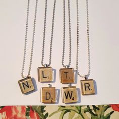 three necklaces with letters that spell out the word'n dwp on them