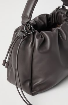 Soft leather is a refined material characterized by a natural grain and a nice supple hand. Drawstring closure Adjustable and detachable shoulder strap Handle Leather lining Internal pocket with zip closure Nickel-free monili decoration Bag is 25 cm (9.84") long, 8 cm (3.15") wide and 18 cm (7.09") high Evening Soft Leather Pouch Bucket Bag, Modern Leather Clutch Bucket Bag, Formal Hobo Pouch Bag With Adjustable Strap, Textured Leather Evening Pouch Bag, Evening Textured Leather Pouch Bag, Brown Textured Leather Evening Bucket Bag, Brown Textured Leather Bucket Bag For Evening, Evening Hobo Bag In Soft Leather, Soft Leather Clutch Bucket Bag