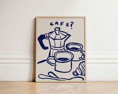 a blue and white poster with the words cafe on it next to a cup of coffee