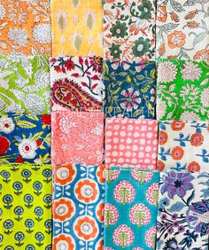 many different colors and patterns of fabric with flowers on them, including blue, green, orange