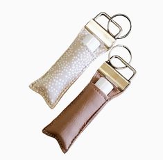 For more great options, please click here:  https://www.etsy.com/ca/shop/StitchesByEmm Keep your lip balm or chapstick handy and always with you with this cute keychain lip balm holder. Choose from either of these: rifle paper co taupe dots fabric or solid dark taupe fabric! ** fits standard size lip balm or chapstick tubes ** attach to purse straps, belt loops, use as a keychain or key fob ** also fits lip gloss pens ** snug fitting so your lip balm stays in place ** each fob will vary accordin Truck Interior Accessories, Keychain Fabric, Chapstick Holder Keychain, Lip Balm Holder, Chapstick Holder, Dark Taupe, Cute Keychain, Gifts For Teachers, Dotted Fabric