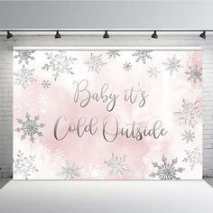 a backdrop with snowflakes on it that says baby it's cold outside