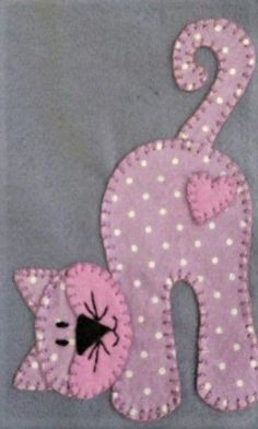 a pink and white cat with a spider on it's back is next to a gray background