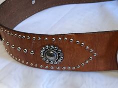 "vintage Brighton wide leather belt Cognac brown with silver accents and silver buckle measures a size 36 and is 2\" wide in almost new preowned condition shows almost no wear beautiful belt" Vintage Formal Belts With Silver Buckle, Elegant Brown Belt With Concho, Elegant Brown Concho Belt, Adjustable Brown Belts With Silver Buckle, Brown Concho Belt, Vintage Silver Leather Belt Buckles, Silver Leather Belt With Antique Buckle, Vintage Brown Belt Buckles With Silver Buckle, Adjustable Brown Belt With Silver Buckle