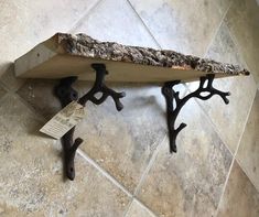 a piece of wood that has been placed on the floor with iron brackets attached to it