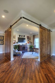 an open living room with sliding barn doors