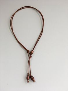 Brown Pearl Leather Lariat Necklace - Etsy Brown Leather Necklace With Adjustable Length, Casual Brown Necklace With Adjustable Cord, Brown Beach Jewelry With Sliding Knot, Brown Sliding Knot Jewelry For Beach, Brown Lariat Jewelry With Adjustable Cord, Adjustable Brown Lariat Necklaces, Adjustable Brown Necklace With Waxed Cord, Brown Lariat Necklace With Adjustable Length, Adjustable Brown Necklace With Sliding Knot