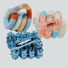 three different types of bracelets are shown in this image, one has an orange tag on it and the other is blue