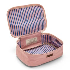 an open pink suitcase with blue and white stripes on the inside, sitting on a white surface