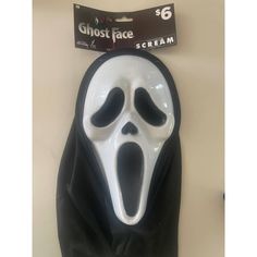 a ghost face mask hanging on the wall