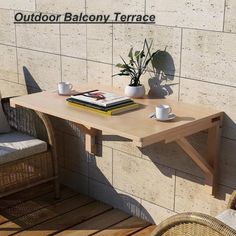 an outdoor balcony terrace with wicker chairs, table and potted plant on it