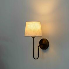 a wall light with a white shade on it