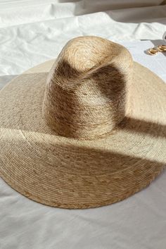 Lack of color Palma Wide Fedora is handmade by artisans in Mexico, our new 100% baked palm leaf hats are perfect for the Summer soiree of your choice. Featuring a cowboy crown and tightly woven pressed palm, this hat is made for Summer. Natural Palm Leaf wide-brimmed western hat 100% Palm Leaf in Natural Inner elastic sweatband to help with fitBrim measures approx. 12 cm / 4.7” Sits higher on head Spot / specialist clean This hat is accredited with a UPF Rating 50+ (Australian Tested) Please note, hat features including straw color and brim width may vary slightly from piece to piece. These hats are individually handcrafted by artisans, each with its own unique character. We want your new hat to be as unique as the person wearing it and consider this a contribution to the unique character Coastal Earrings, Western Hat, Lack Of Color, Summer Soiree, Western Hats, Fleetwood Mac, Palm Leaf, Earrings Collection, Wide Brimmed