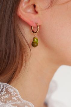 Introducing our Pear earrings! Featuring our brand new Pear charm! <3  Every picnic blanket piece is lovingly designed and handcrafted completely in-house and perfectly finished in our jewellery studio.  Every individual glass feature charm takes around half an hour to delicately form by hand in the flame, reaching temperatures of up to 800 degrees celsius, before heading to the kiln to soak for around 8 hours in the warmth to ensure strength and longevity. The charms are then washed by hand to Pear Earrings, Jewelry Studio, Sterling Silver Hoops, Jewelry Earrings Hoops, Silver Hoops, Glass Jewelry, Earrings Handmade, Handmade Natural, Jewelry Pieces