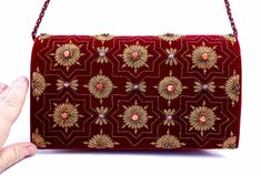 "Burgundy velvet clutch bag, zardozi evening bag, embroidered with copper medallions and embellished with genuine semi precious stones, to give an opulent, multidimensional dazzling effect. This is a gorgeous wardrobe investment piece! A classic design that will never go out of style! A modern heirloom to be cherished! Add instant glamour and elegance to any ensemble! Perfect for any evening occasion, be it wedding, gala, cocktail party. The word Zardozi means \"gold thread\". It is an elaborate Formal Evening Bag With Zari Work For Festivals, Formal Evening Bag With Handwork For Festivals, Luxury Clutch With Mirror Work For Formal Occasions, Luxury Festive Evening Bag With Zari Work, Luxury Formal Clutch With Mirror Work, Luxury Evening Bag With Zari Work For Festive Season, Formal Clutch With Mirror Work For Festivals, Luxury Evening Bag With Zari Work For Reception, Festive Formal Evening Bag With Mirror Work