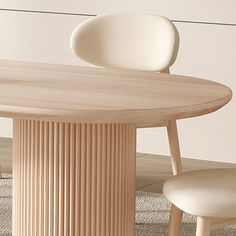 a wooden table with two chairs and a vase on the floor in front of it