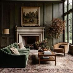 a living room filled with furniture and a fire place in front of a painting on the wall