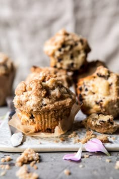 muffins with crumbs scattered around them on a cutting board