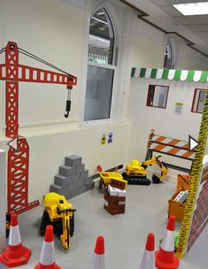 there are construction equipment on the floor in this school room, and some cones around them