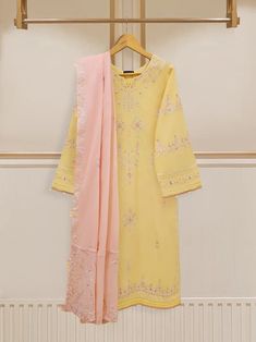 Vibrant and fashionable embroidered lawn shirt with dupatta perfect for adding a touch of elegance and style to your wardrobe. Made from high-quality lawn fabric, this shirt offers comfort and breathability, making it an ideal choice. Length : 46" Dupatta Fabric : Lawn Resham Embroidered Lawn Suit In Chinon, Chinon Lawn Suit With Dabka Work, Chinon Lawn Suit With Dabka Work Straight Kurta, Yellow Naqshi Lawn Suit For Wedding, Yellow Lawn Suit With Naqshi For Wedding, Yellow Mulmul Dupatta For Eid, Yellow Salwar Kameez With Dabka Work On Mulmul, Yellow Salwar Kameez With Dabka Work In Mulmul, Yellow Embroidered Cotton Lawn Suit