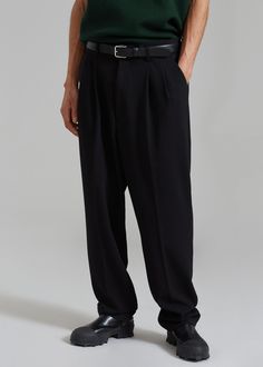 Color: Black Midweight woven fabric Relaxed fit Wide leg Belt loops Pleated detailing Traveler's crease Slant hip pockets Zip fly Hook and bar closure Unlined 70% Polyester 28% Rayon 2% Spandex Dry Clean By The Frankie Shop. Imported The Frankie Shop, Leg Belt, Frankie Shop, Pleated Trousers, Woven Fabric, Wide Leg, Trousers, Relaxed Fit, Spandex