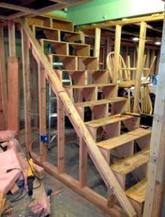 a wooden staircase being built in a garage