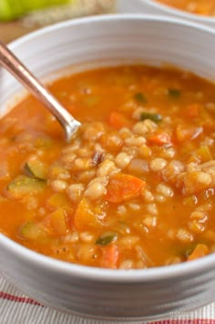 a white bowl filled with soup on top of a table