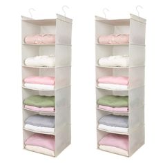 two white shelves with folded clothes on them